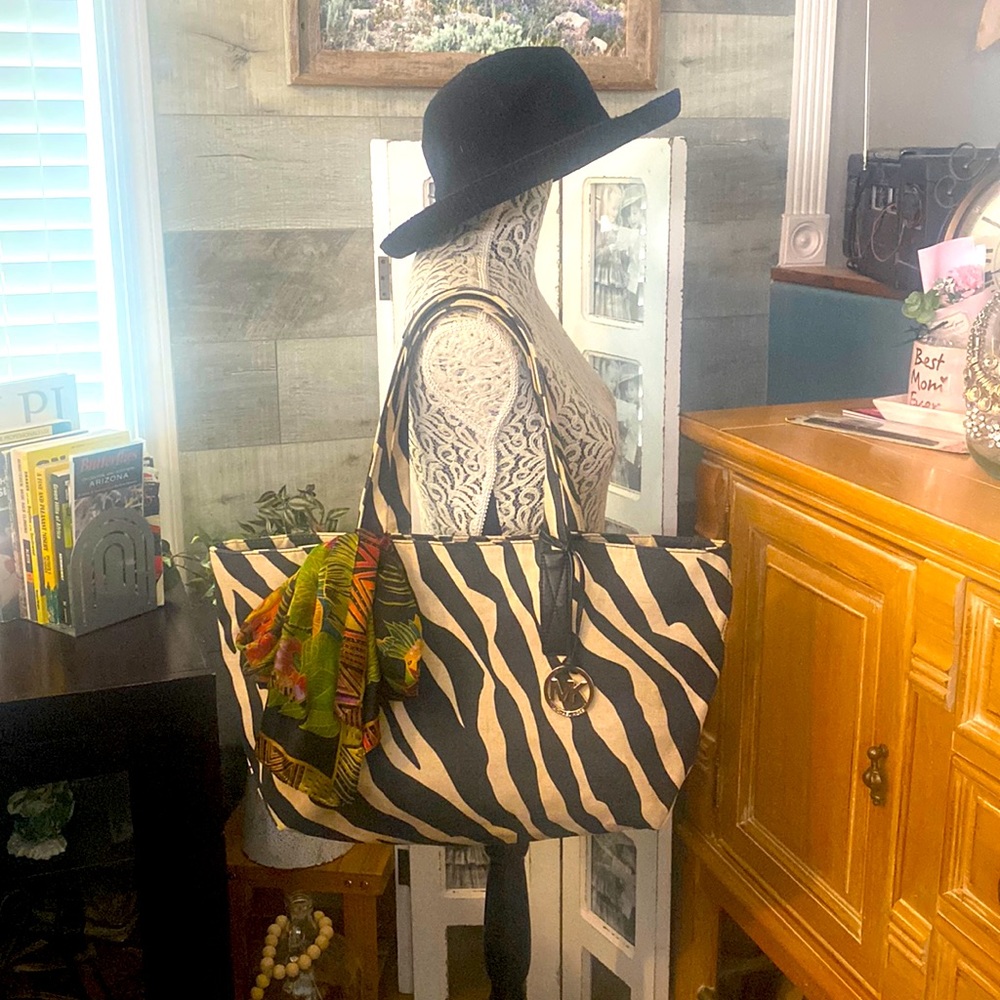 Michael Kors animal print canvas tote with leather trim and a black wallaroo hat